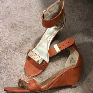 Cognac wedge sandal with gold accents.